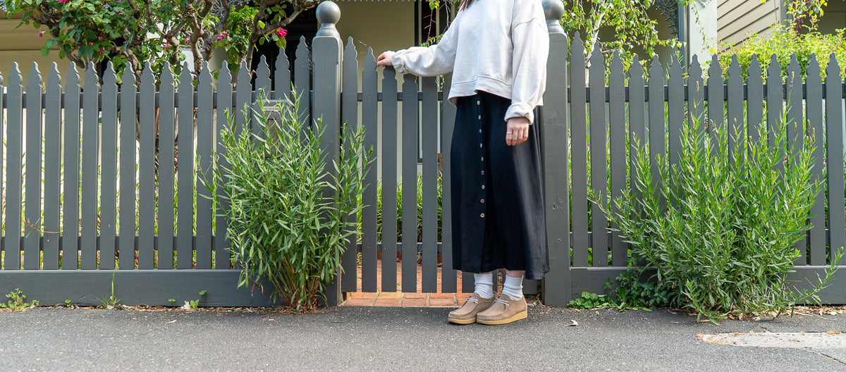 Two women walking on a city path, wearing Clay and Sky coloured shoes.
